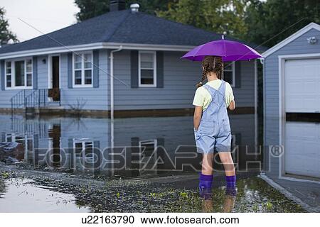 USA, Illinois, Chillicothe, Mixed race girl (8-9) standing in water and holding umbrella, rear view View Large Photo Image Stock Image - USA, Illinois, Chillicothe, Mixed race girl (8-9) standing in water and holding umbrella, rear view. Fotosearch