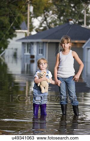 USA, Illinois, Chillicothe, Two girls (2-3, 8-9) holding hands, Standing in water and looking at camera View Large Photo Image Stock Image - USA, Illinois, Chillicothe, Two girls (2-3, 8-9) holding hands, Standing in water and looking at camera. Fotosearch