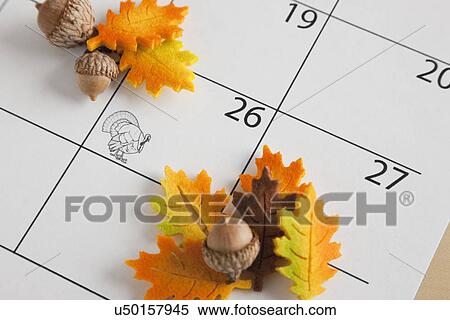Stock Photography - USA, Illinois, Metamora, Acorns on calendar. Fotosearch