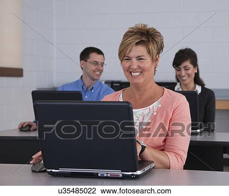 USA, Illinois, Metamora, Adult students in computer lab View Large Photo Image Stock Image - USA, Illinois, Metamora, Adult students in computer lab. Fotosearch