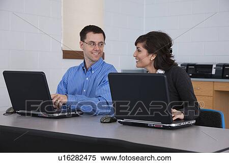 Stock Photography - USA, Illinois, Metamora, Adult students in computer lab. Fotosearch