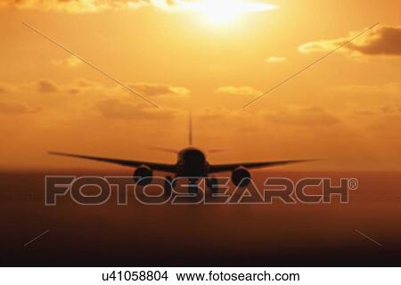 Picture - USA, Illinois, Metamora, Airplane on runway at sunset. Fotosearch