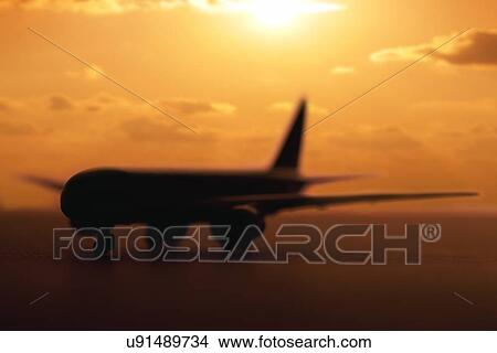 Picture - USA, Illinois, Metamora, Airplane on runway at sunset. Fotosearch
