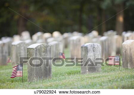 Picture - USA, Illinois, Metamora, American flags and tombstones on cemetery. Fotosearch