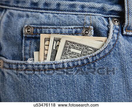 Stock Photo - USA, Illinois, Metamora, American banknotes in front pocket of blue jeans. Fotosearch