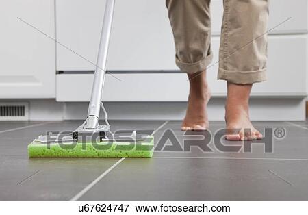 USA, Illinois, Metamora, Barefoot woman cleaning kitchen floor, low section View Large Photo Image Stock Photo - USA, Illinois, Metamora, Barefoot woman cleaning kitchen floor, low section. Fotosearch