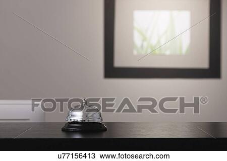 Stock Image - USA, Illinois, Metamora, Bell at hotel reception. Fotosearch