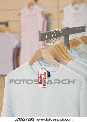 USA, Illinois, Metamora, Black Friday sale tag on clothing hanging on rail in shop View Large Photo Image Stock Image - USA, Illinois, Metamora, Black Friday sale tag on clothing hanging on rail in shop. Fotosearch