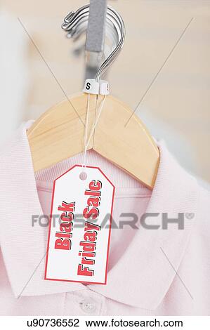 USA, Illinois, Metamora, Black Friday sale tag on clothing hanging on rail in shop View Large Photo Image Stock Image - USA, Illinois, Metamora, Black Friday sale tag on clothing hanging on rail in shop. Fotosearch