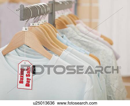 USA, Illinois, Metamora, Black Friday sale tag on clothing hanging on rail in shop View Large Photo Image Stock Photograph - USA, Illinois, Metamora, Black Friday sale tag on clothing hanging on rail in shop. Fotosearch