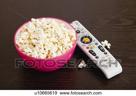 USA, Illinois, Metamora, Bowl of popcorn and remote control on table View Large Photo Image Stock Photo - USA, Illinois, Metamora, Bowl of popcorn and remote control on table. Fotosearch