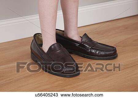 USA, Illinois, Metamora, Boy (6-7) in his father shoes View Large Photo Image Stock Image - USA, Illinois, Metamora, Boy (6-7) in his father shoes. Fotosearch
