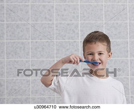 Stock Image - USA, Illinois, Metamora, Boy (6-7) brushing teeth. Fotosearch