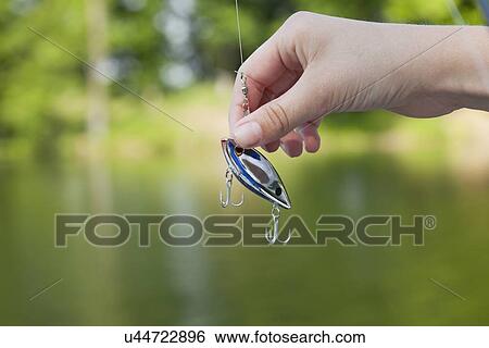 USA, Illinois, Metamora, Boy's (10-11) hand holding fishing hook View Large Photo Image Stock Photograph - USA, Illinois, Metamora, Boy's (10-11) hand holding fishing hook. Fotosearch