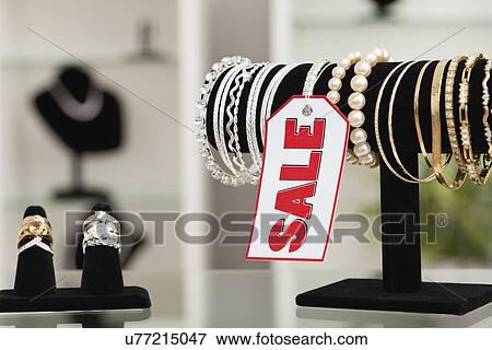 Stock Photo - USA, Illinois, Metamora, bracelets and rings on display in jewelry store. Fotosearch