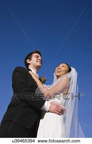 USA, Illinois, Metamora, Bride and groom embracing View Large Photo Image Picture - USA, Illinois, Metamora, Bride and groom embracing. Fotosearch