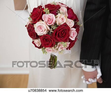 USA, Illinois, Metamora, Bride and groom with bouquet View Large Photo Image Picture - USA, Illinois, Metamora, Bride and groom with bouquet. Fotosearch