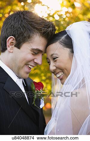 USA, Illinois, Metamora, Bride and groom face to face View Large Photo Image Picture - USA, Illinois, Metamora, Bride and groom face to face. Fotosearch