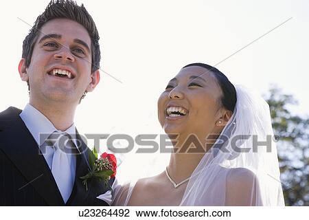 Stock Image - USA, Illinois, Metamora, Bride and groom laughing. Fotosearch
