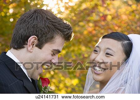 Stock Image - USA, Illinois, Metamora, Bride and groom laughing. Fotosearch