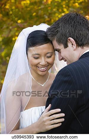 Stock Image - USA, Illinois, Metamora, Bride and groom laughing. Fotosearch