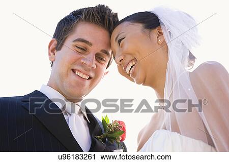 Stock Image - USA, Illinois, Metamora, Bride and groom laughing. Fotosearch