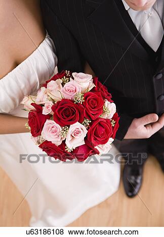 Stock Photo - USA, Illinois, Metamora, Bride and groom with bouquet. Fotosearch