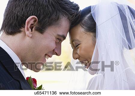 USA, Illinois, Metamora, Bride and groom laughing View Large Photo Image Stock Photograph - USA, Illinois, Metamora, Bride and groom laughing. Fotosearch