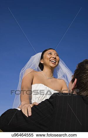 USA, Illinois, Metamora, Bride and groom embracing View Large Photo Image Stock Photography - USA, Illinois, Metamora, Bride and groom embracing. Fotosearch