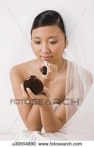 USA, Illinois, Metamora, Bride applying lipstick View Large Photo Image Stock Image - USA, Illinois, Metamora, Bride applying lipstick. Fotosearch