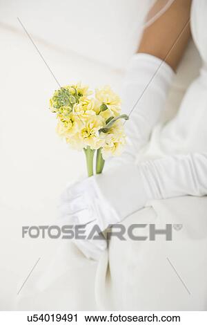 Stock Image - USA, Illinois, Metamora, Bride holding flowers. Fotosearch