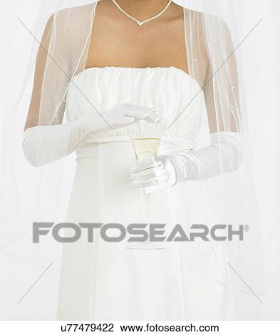 USA, Illinois, Metamora, Bride holding glass of champagne View Large Photo Image Stock Image - USA, Illinois, Metamora, Bride holding glass of champagne. Fotosearch