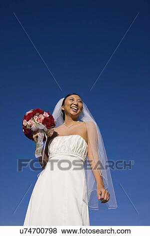 Stock Photo - USA, Illinois, Metamora, Bride holding bouquet. Fotosearch