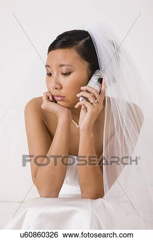 USA, Illinois, Metamora, Bride using mobile phone View Large Photo Image Stock Photograph - USA, Illinois, Metamora, Bride using mobile phone. Fotosearch
