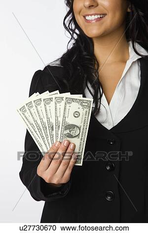 USA, Illinois, Metamora, Business woman holding dollar bills View Large Photo Image Stock Image - USA, Illinois, Metamora, Business woman holding dollar bills. Fotosearch
