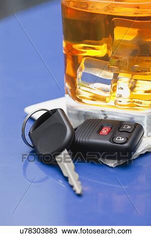 Stock Image - USA, Illinois, Metamora, Car keys and glass of whiskey. Fotosearch