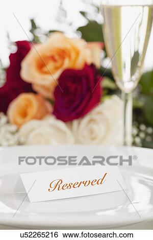 Stock Photograph - USA, Illinois, Metamora, Card with reservation on plate. Fotosearch