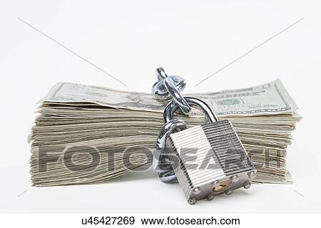 USA, Illinois, Metamora, Chained up stack of US money View Large Photo Image Stock Photo - USA, Illinois, Metamora, Chained up stack of US money. Fotosearch