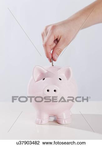 USA, Illinois, Metamora, Child's (10-11) hand putting money into piggy bank View Large Photo Image Stock Image - USA, Illinois, Metamora, Child's (10-11) hand putting money into piggy bank. Fotosearch