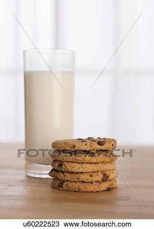 Stock Image - USA, Illinois, Metamora, Chocolate chip cookies beside glass of milk. Fotosearch