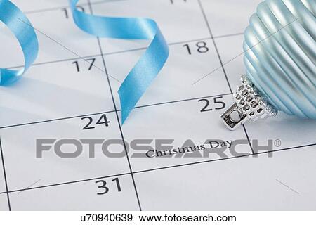 USA, Illinois, Metamora, Christmas bulb laying on calendar View Large Photo Image Stock Photo - USA, Illinois, Metamora, Christmas bulb laying on calendar. Fotosearch