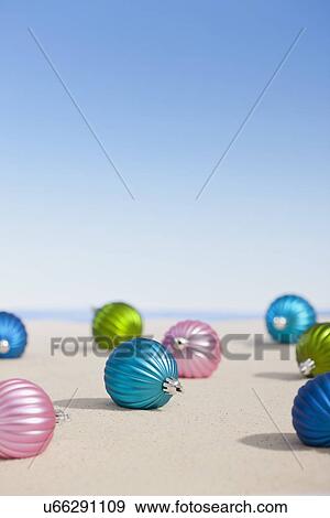 Stock Photo - USA, Illinois, Metamora, Christmas baubles lying on desert. Fotosearch