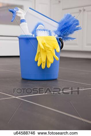 Stock Photograph - USA, Illinois, Metamora, cleaning equipment in bucket on kitchen floor. Fotosearch