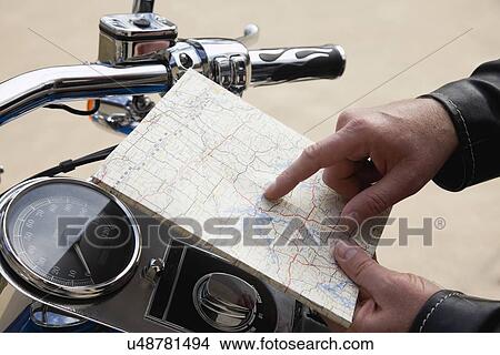 USA, Illinois, Metamora, Close up of man's hand holding map near motorcycle handlebars View Large Photo Image Picture - USA, Illinois, Metamora, Close up of man's hand holding map near motorcycle handlebars. Fotosearch