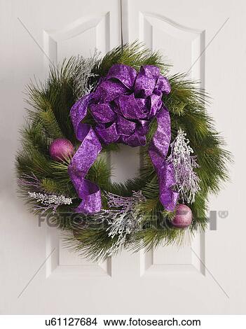 Picture - USA, Illinois, Metamora, Close up of Christmas wreath on door. Fotosearch