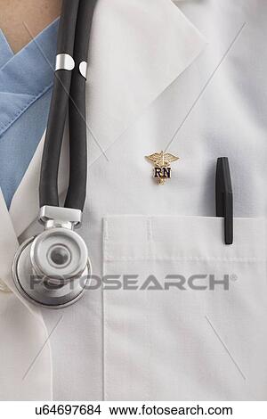 Picture - USA, Illinois, Metamora, Close up of female nurse chest with stethoscope. Fotosearch