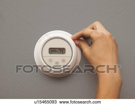 USA, Illinois, Metamora, close-up of woman adjusting thermostat View Large Photo Image Stock Image - USA, Illinois, Metamora, close-up of woman adjusting thermostat. Fotosearch