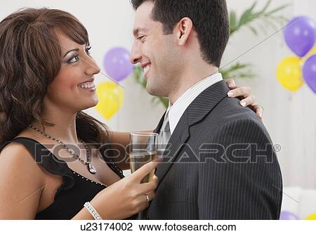Stock Image - USA, Illinois, Metamora, Close-up of couple dancing at New Year's Eve party. Fotosearch