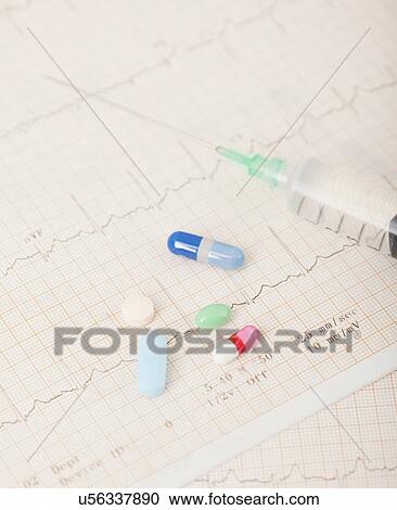 Stock Image - USA, Illinois, Metamora, Close up of medicines and syringe on medical record. Fotosearch