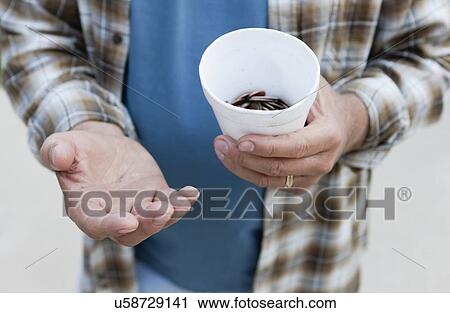 Stock Image - USA, Illinois, Metamora, Close-up of man begging for money. Fotosearch